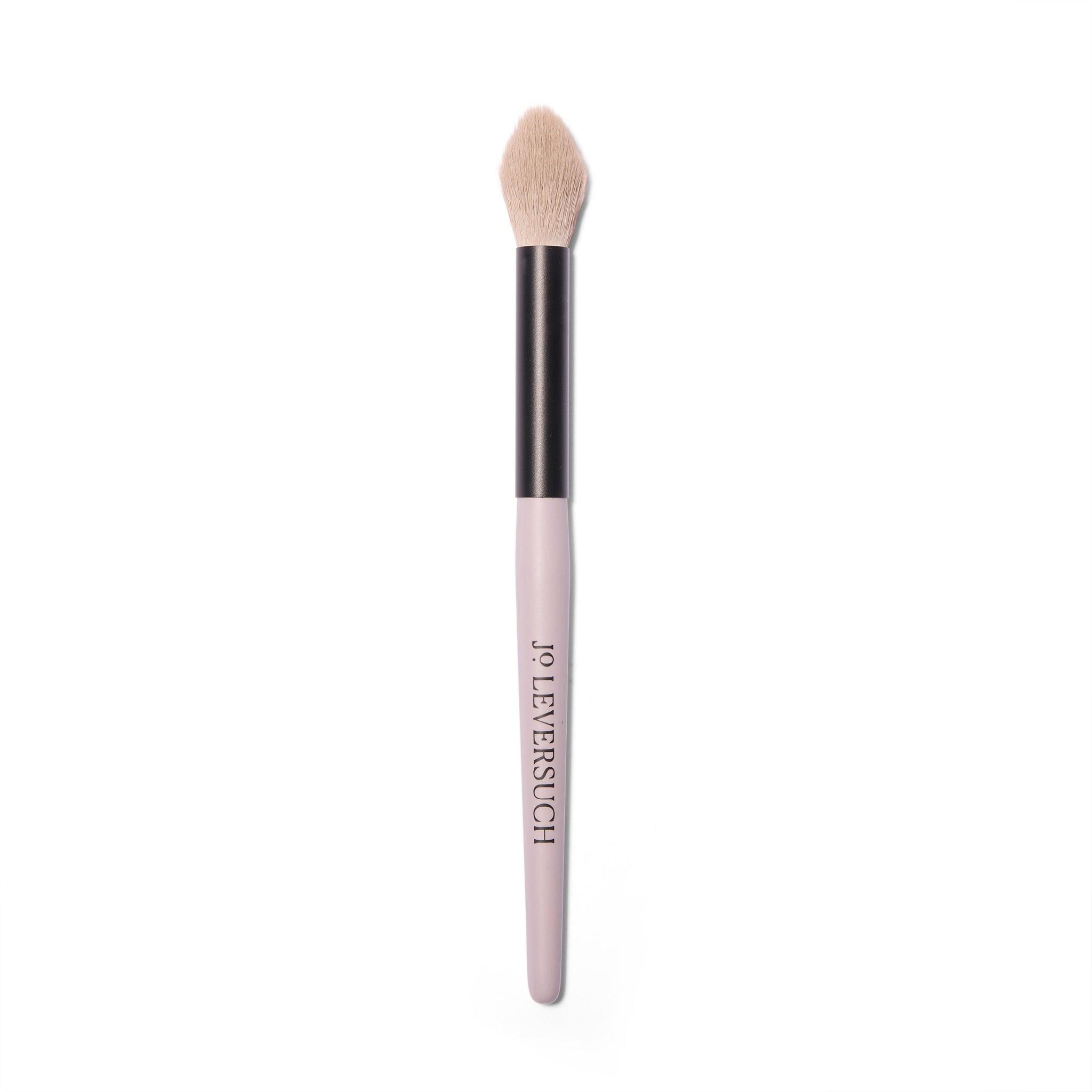 Full length view of the Jo Leversuch Untitled No. 1 Multi-Use Brush. The natural hair bristles are a dusty pink grey. The wooden handle is painted a rosy grey.