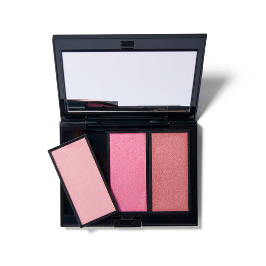 The black Compact Case II, open with the mirror showing. There are three shades of blush in the image, the two on the right inserted into the case and one pan of blush is resting on top of another at an angle showing that the blush pans pop out.