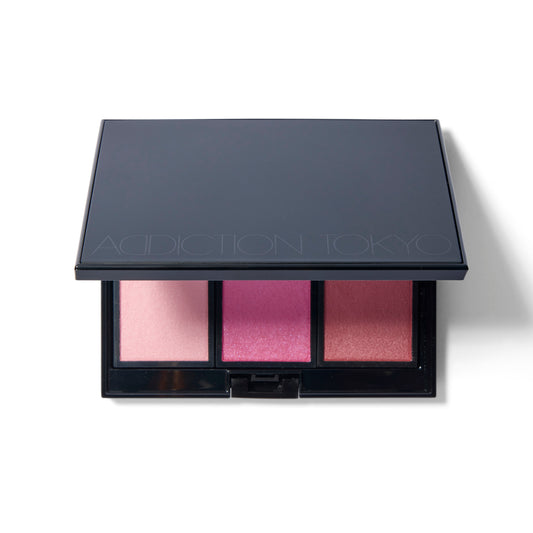 The black Compact Case II, slightly open with a sliver of three shades of blush showing.