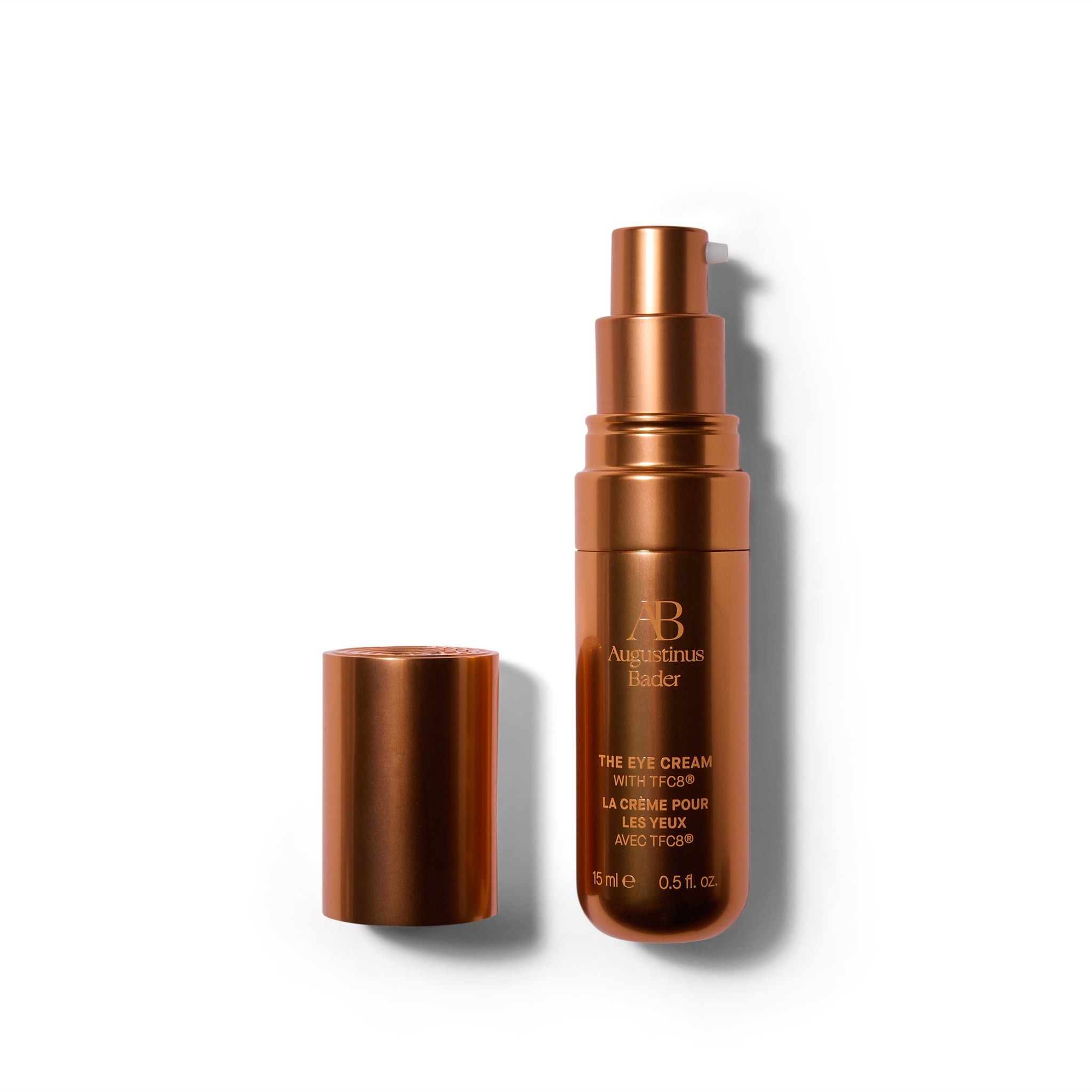 A matte metallic deep orange bottle with the cap off, and the cap is to the left. The font is a similar orange shade.