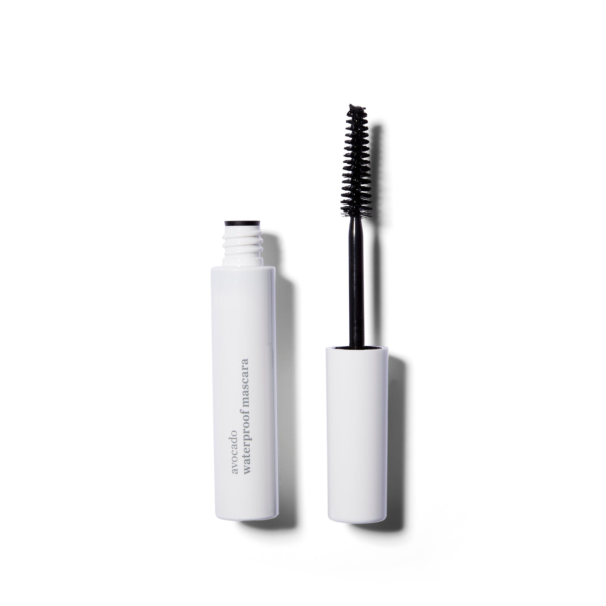 An open tube of the Ere Perez Avocado Waterproof Mascara. The wand is to the left of the open tube.
