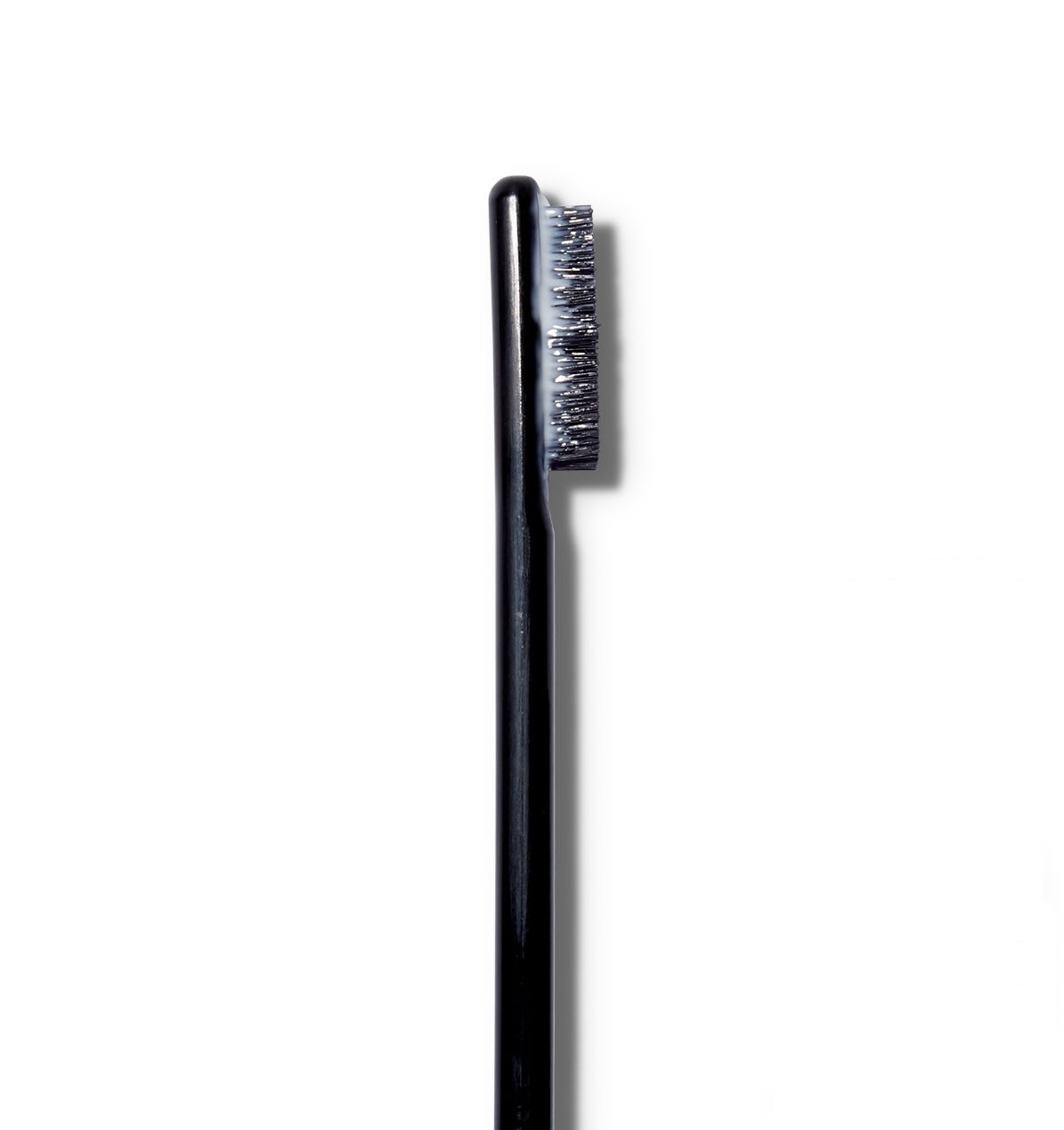 A close up of the The Surratt Expressioniste brow pomade brush with product on it.