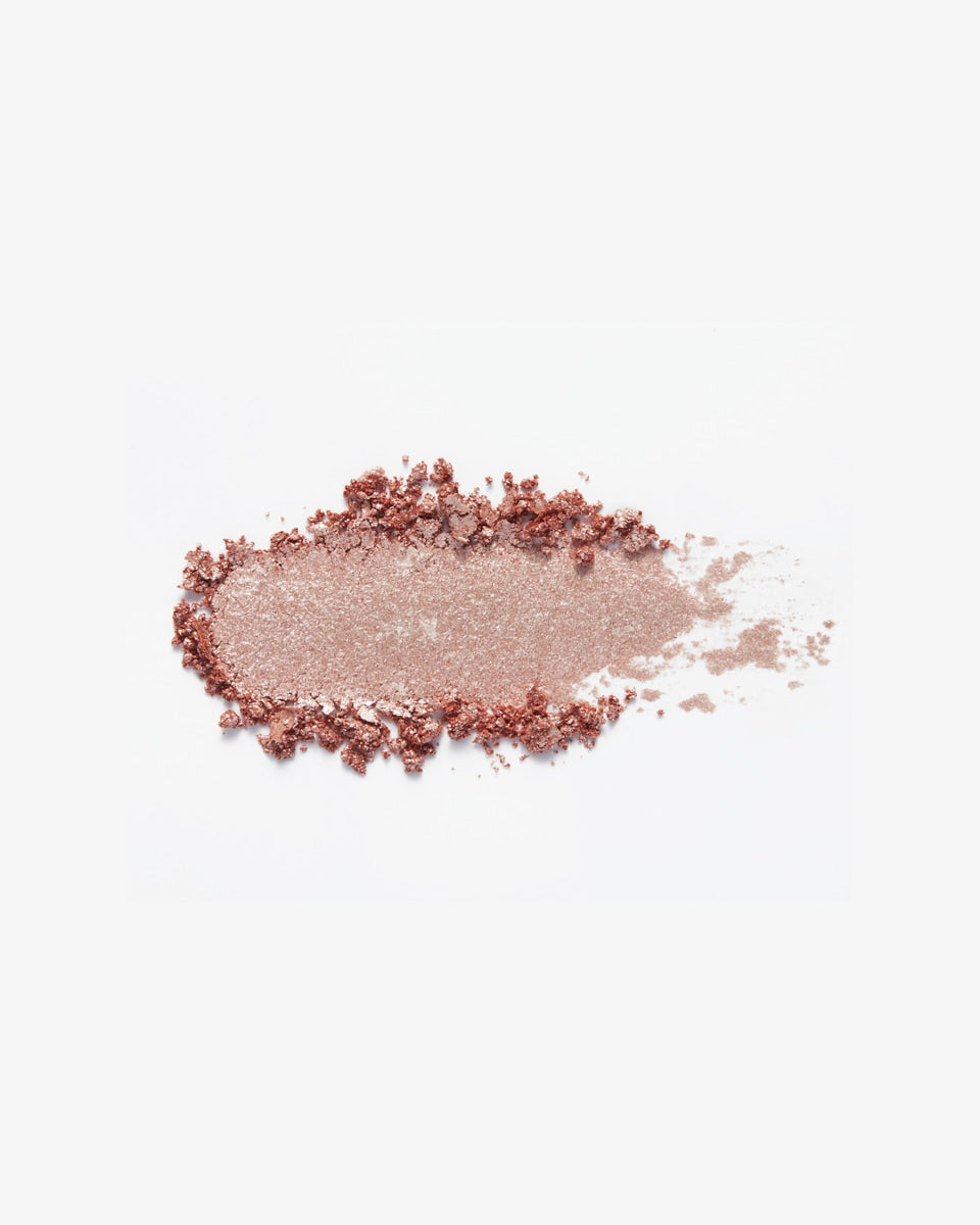 A swatch of shimmery pink eyeshadow.