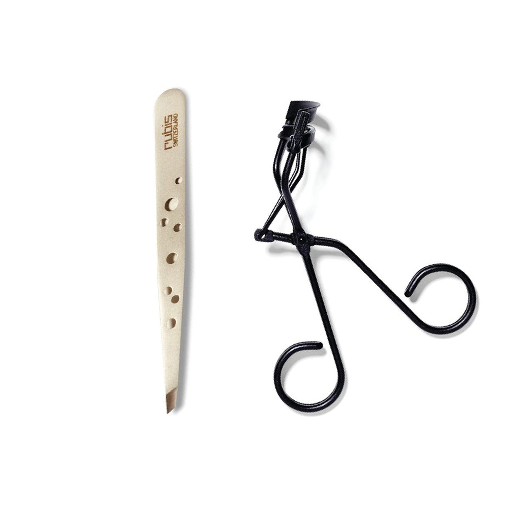 Matte silver Rubis Precision Slanted Tweezers next to the matte black Relevee eyelash curler from Surratt. The eyelash curler is closed.
