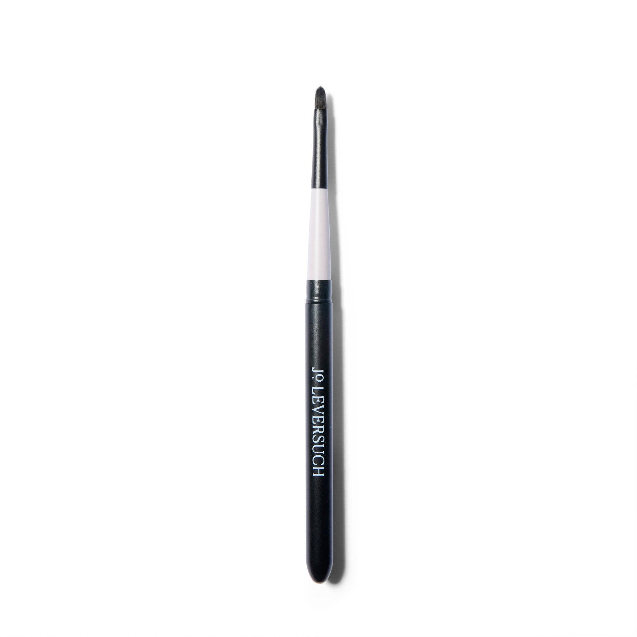 Fine tipped application brush, open, with the brush inserted into the top of the case.