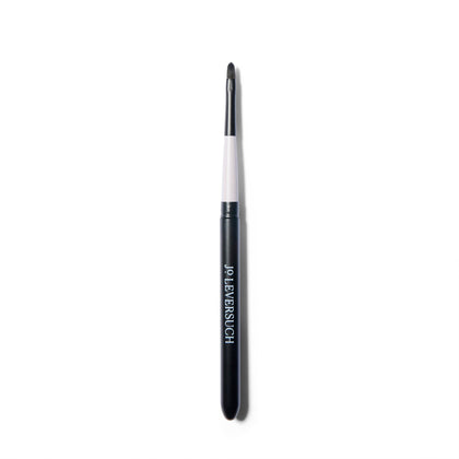 Fine tipped application brush, open, with the brush inserted into the top of the case.