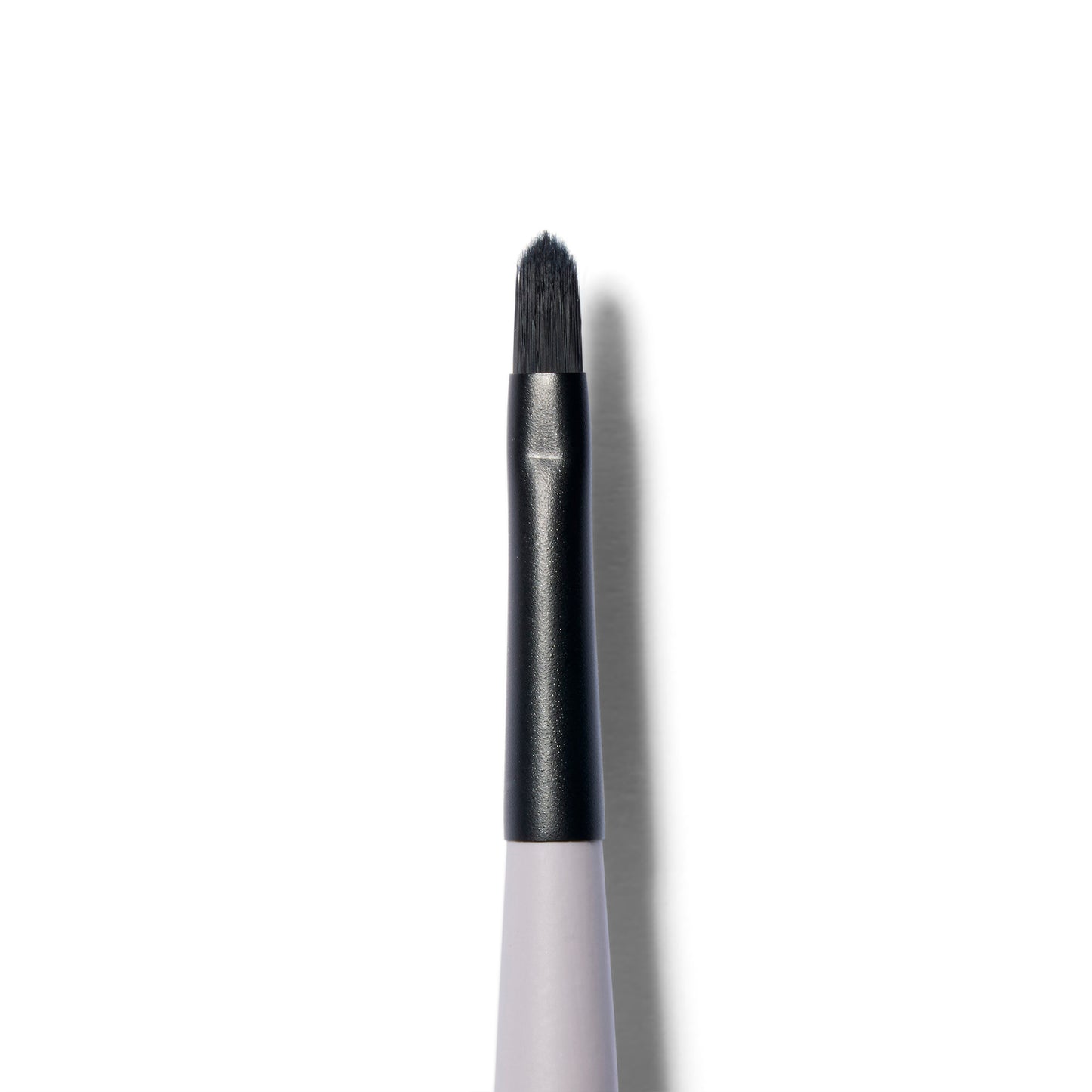 A close up of the  brush of the  fine tipped application brush. The brush hairs are black and slightly tapered.