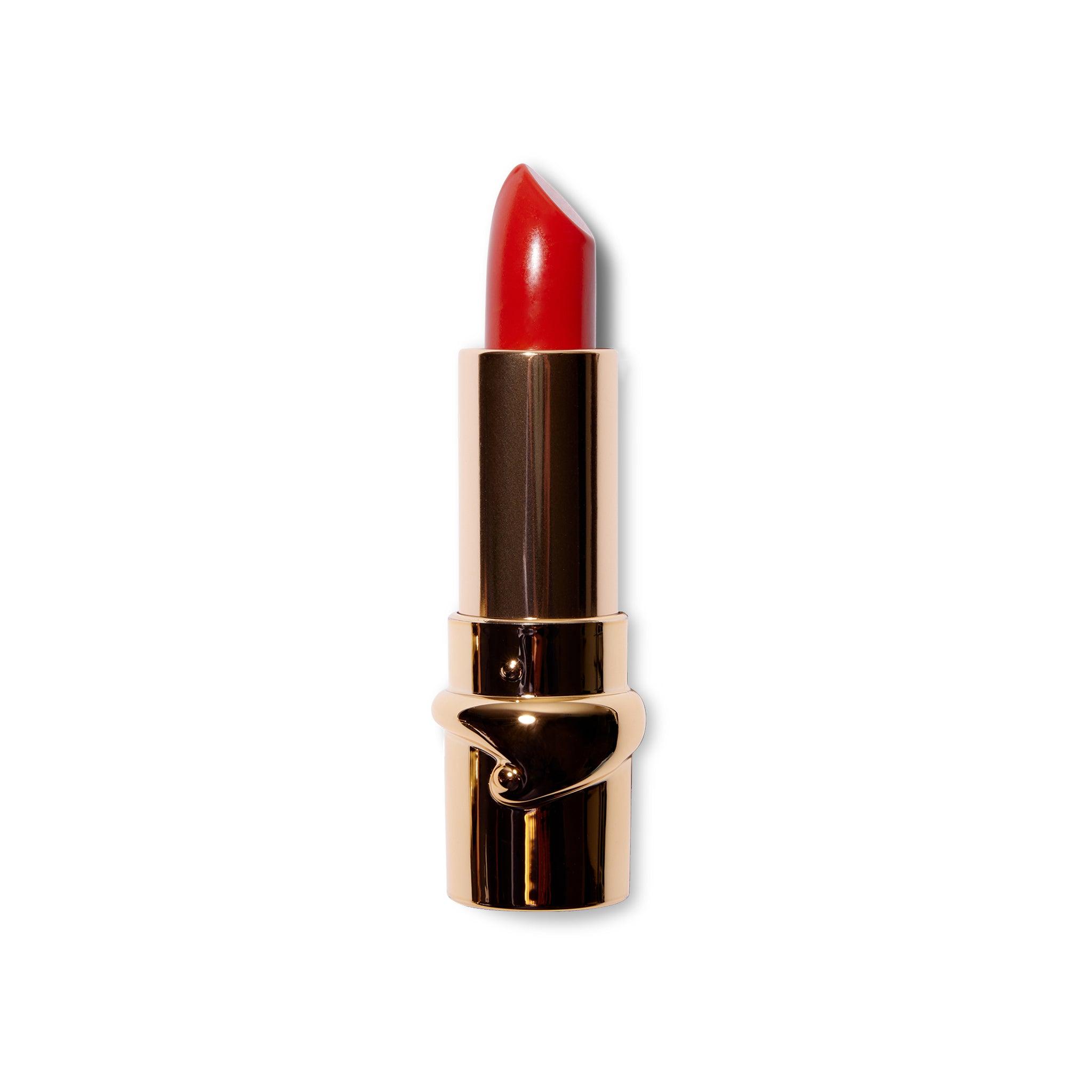 The Julie Hewlett matte Noir lipstick in Belle is wound up and the bullet is visible in the gold component.