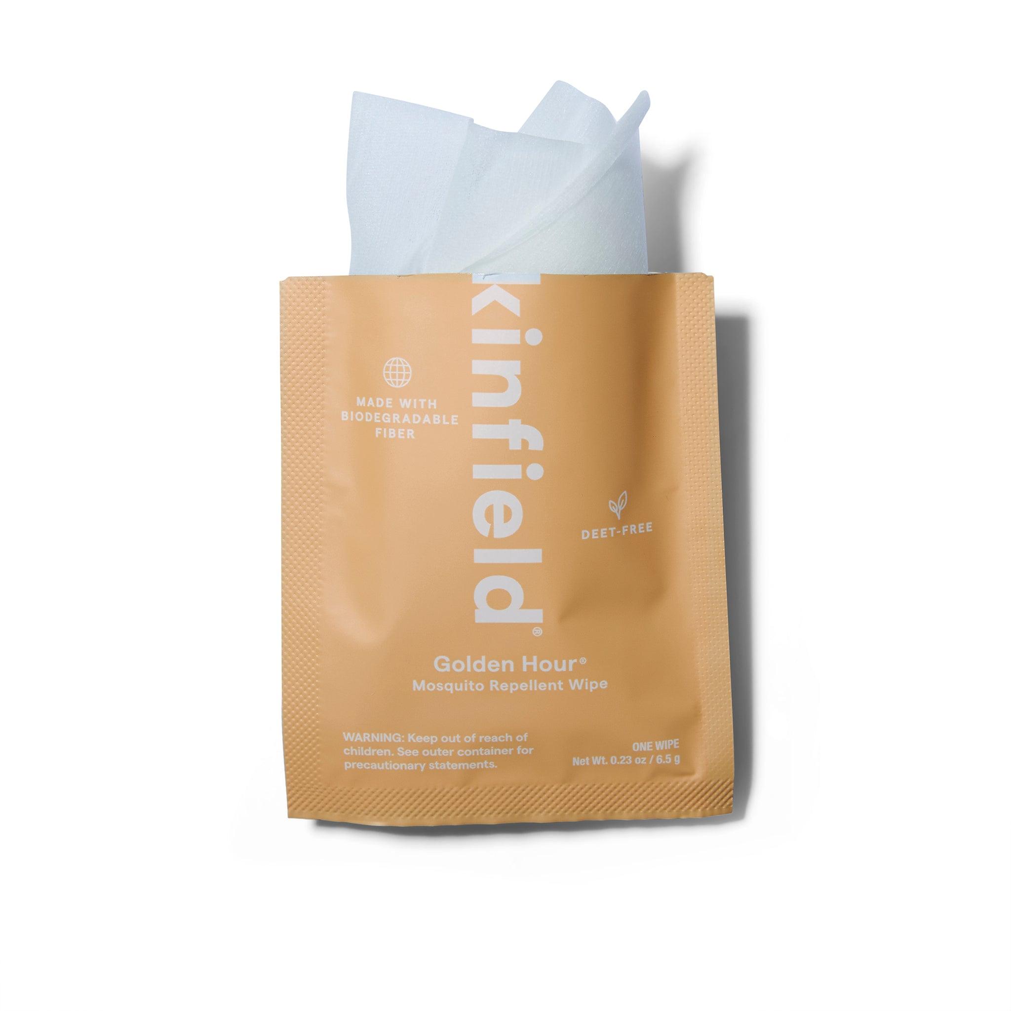 Individual sachet of the Kinfield Golden Hour Mosquito Repellant Wipes. The sachet has been cut open and the white towelette is poking out.