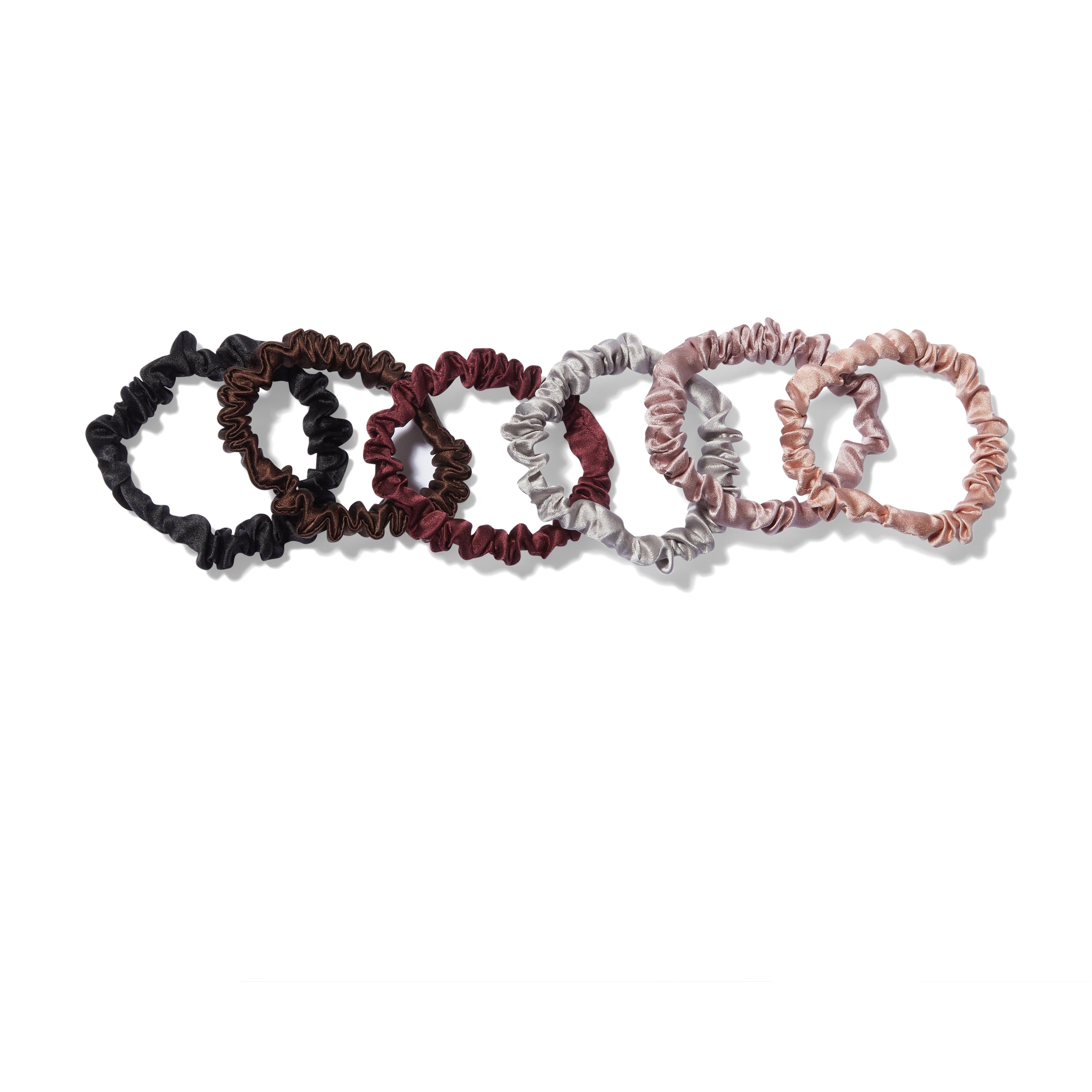 6 Krystell Barraza silk hair ties in a row in a variety of colors.