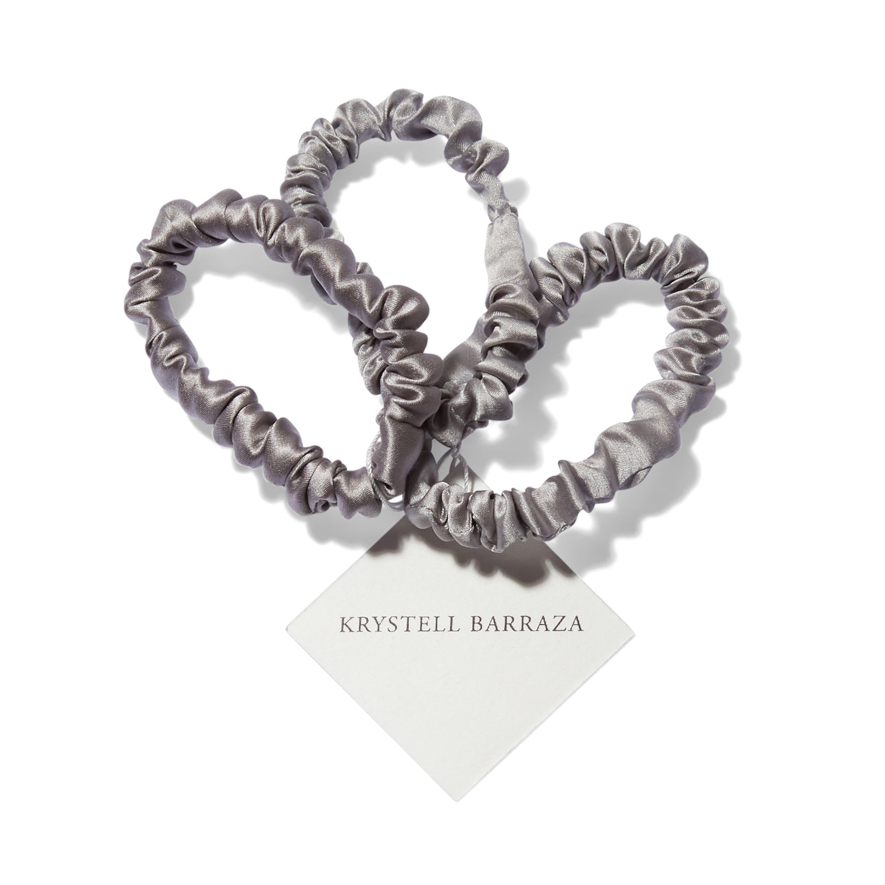 Three 6 Krystell Barraza silk hair ties in Sterling with the logo tag attached.