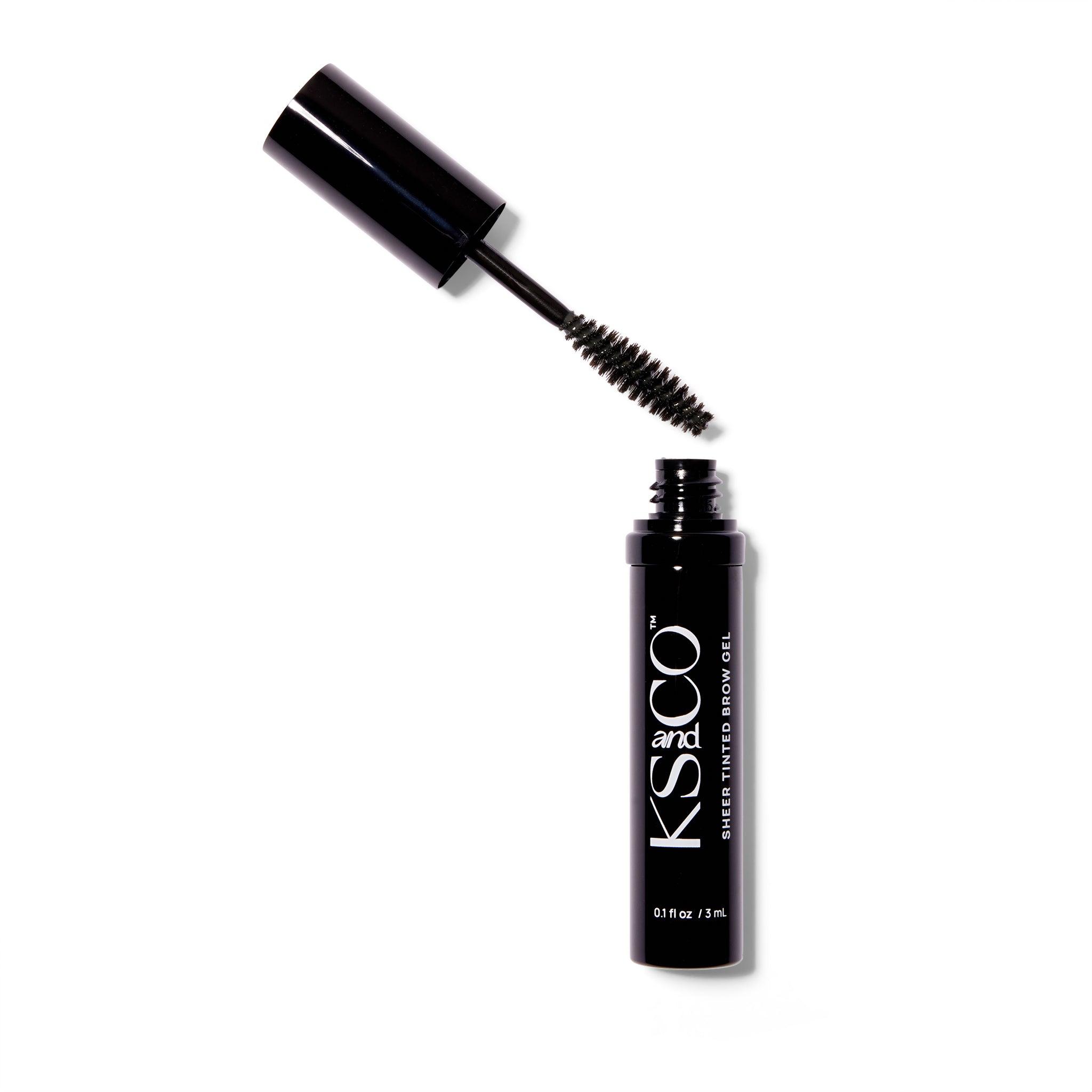 A black metal tube of the KS&CO Sheer Tinted Brow Gel. The wand is out of the container and to the left.