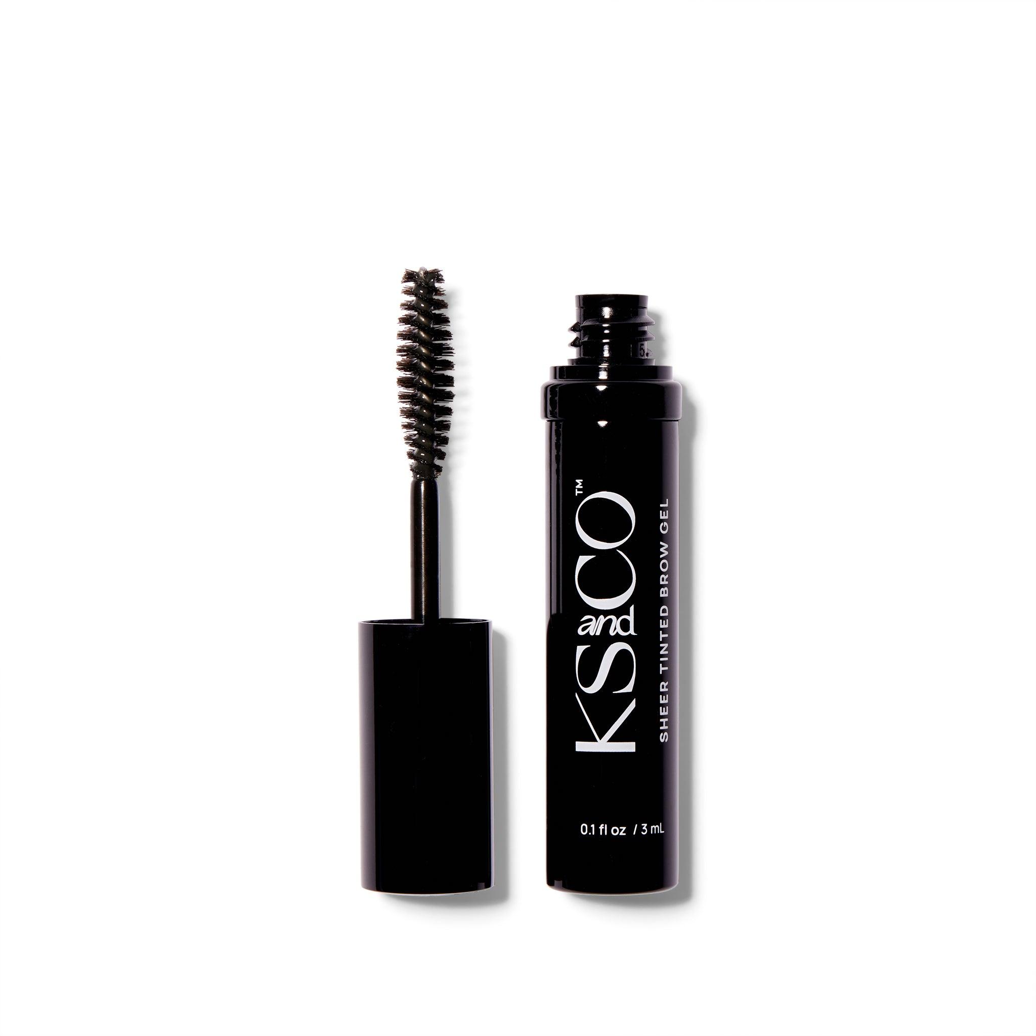 A black metal tube of the KS&CO Sheer Tinted Brow Gel. The wand is out of the container and next to the continue on the left side.