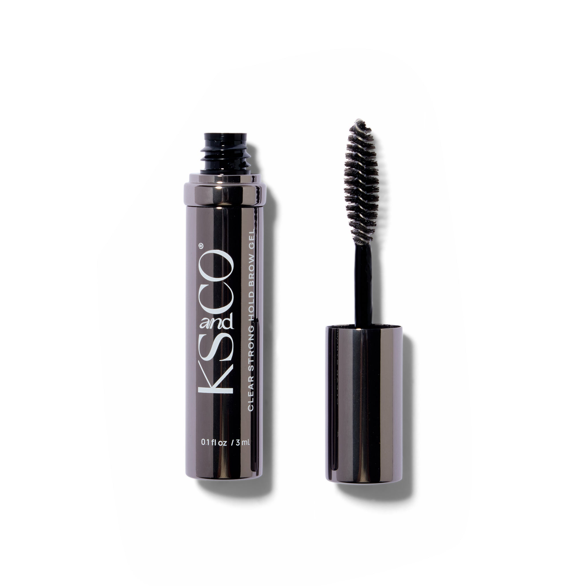 Dark chrome cosmetic tube with white text. The spoolie wand is next to it.