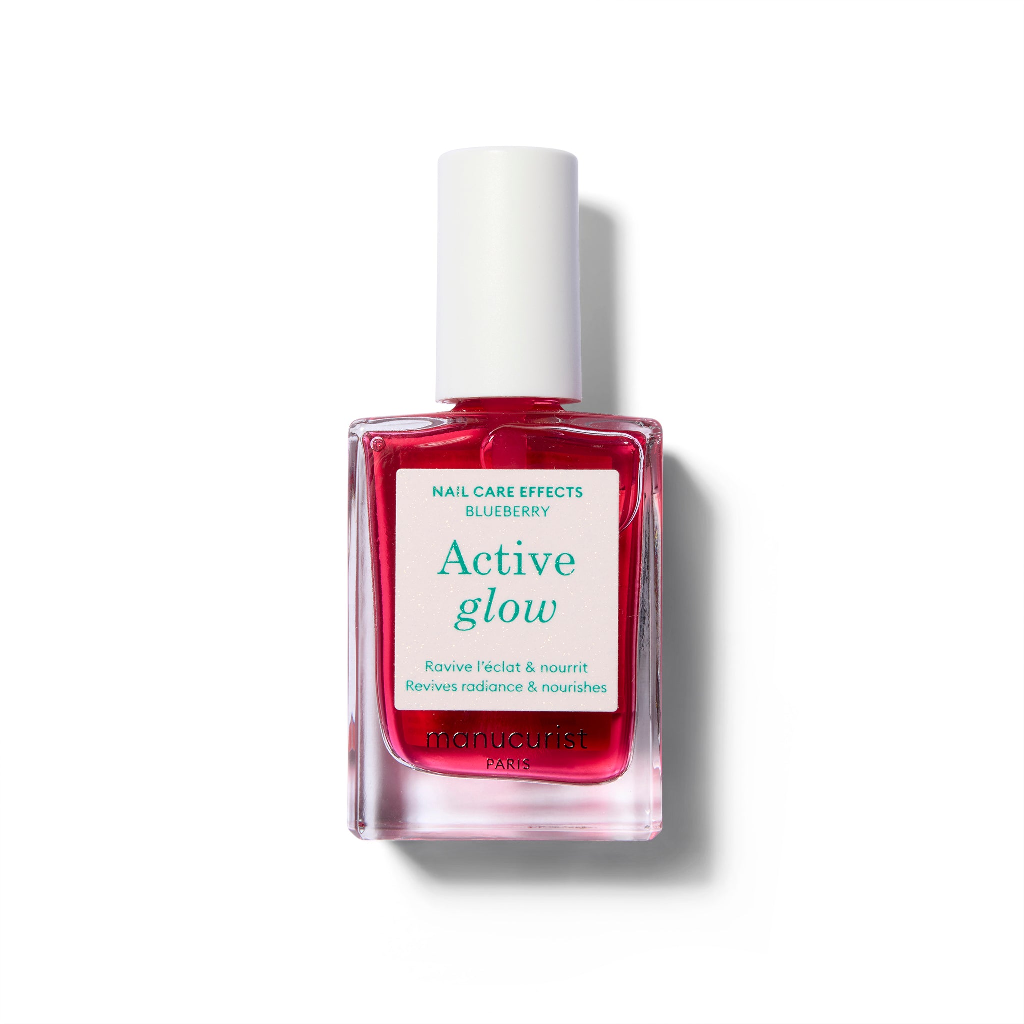 A clear bottle of nail polish with label with green text and a white cap. The polish color is a sheer, light cool-toned pink.