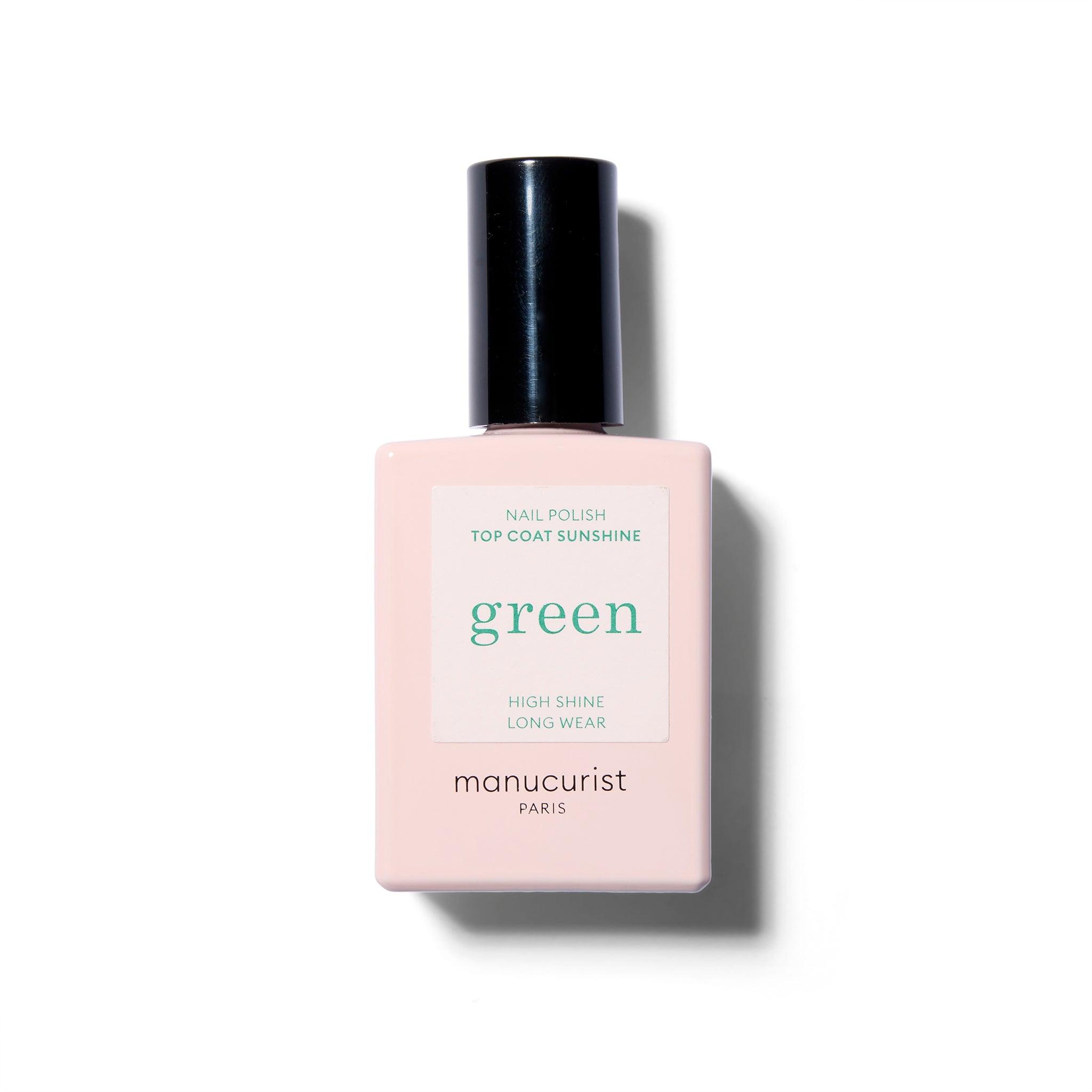 A pink nail polish bottle with a white label with green text. The cap is black.