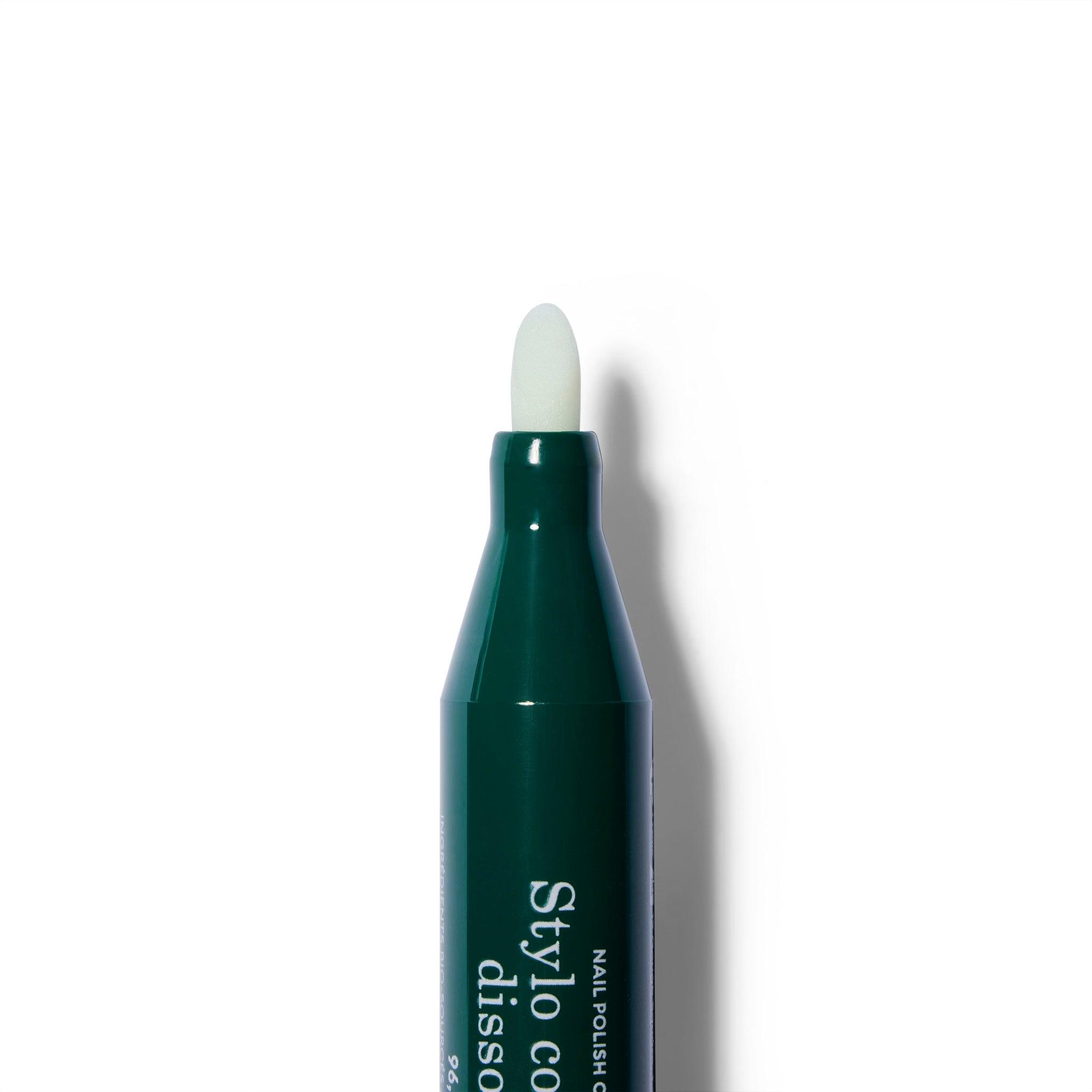 The cap is off of the green nail polish removing pen. The removal nib is showing.