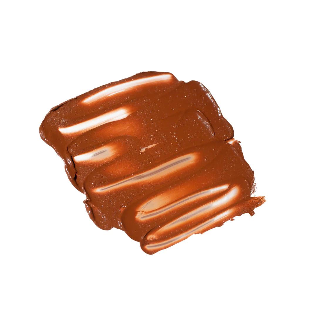A swatch of the Noto Organics Multibenne Stick in Fluxus, a warm russet shade.
