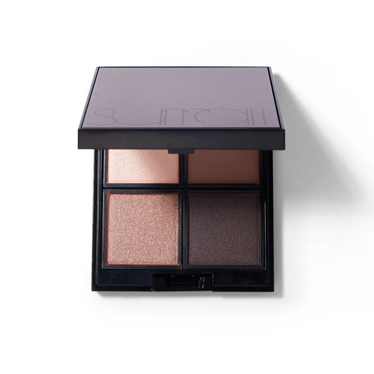 The Surratt Beyond Beige eyeshadow quad with neutral shades. A pale nude, a warm taupe, a caramel brown and deep brown shade. The lid is over the eyeshadows so you cannot see the mirror.