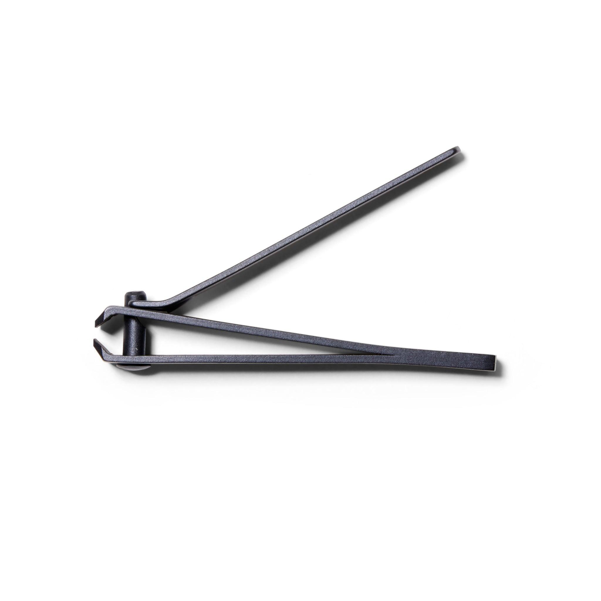 Side view  showing The Big Clip, the matte black metal large nail clippers from ten over ten. The clippers are open.