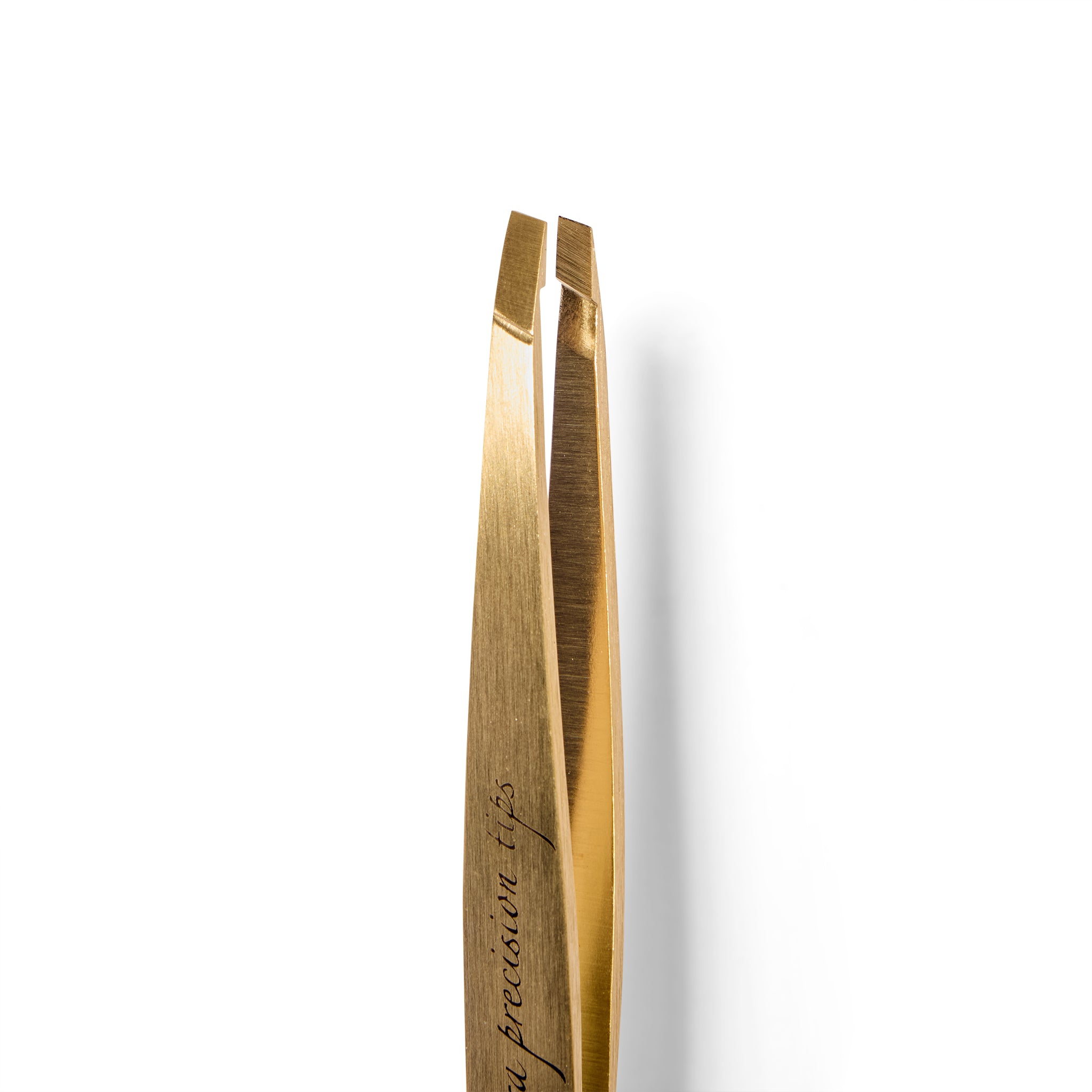 Close up of gold-colored tweezers on a white background
