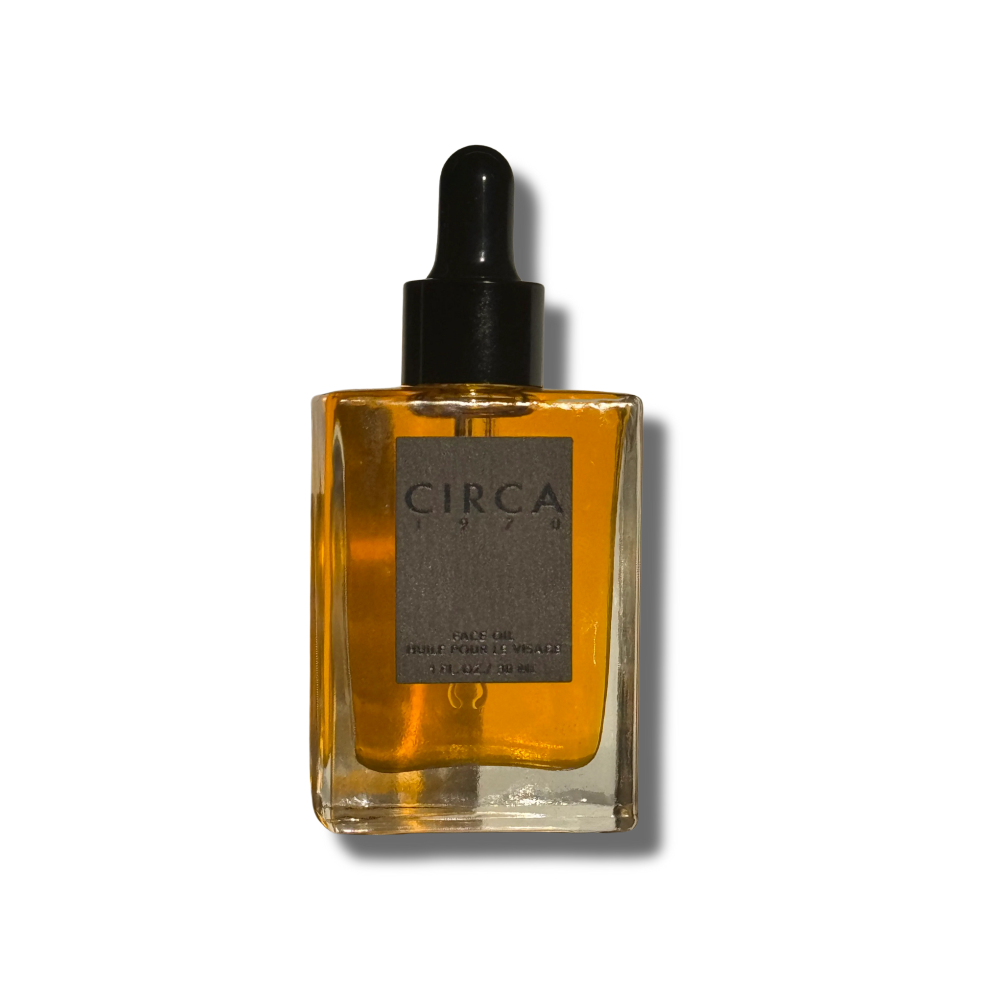 Glass bottle with dropper and amber liquid on a white background