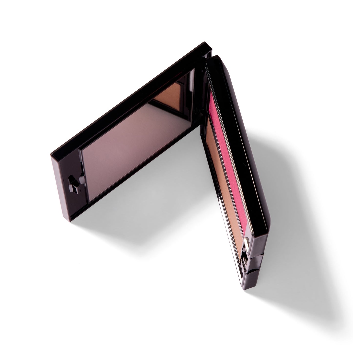 The black Compact Case I, slightly open and on it's side. You can see the mirror and a sliver of two blush colors inside the case.