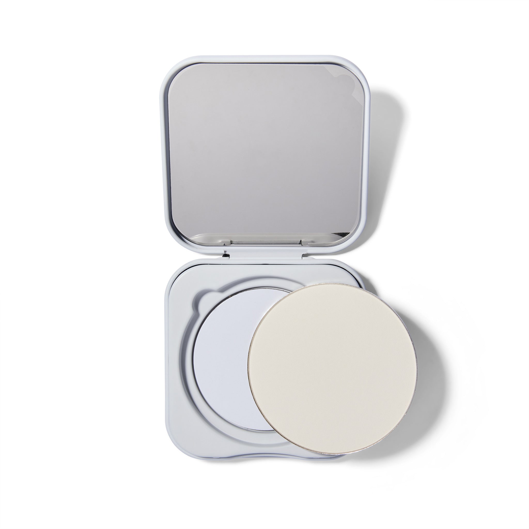 Compact powder in an open case on a white background