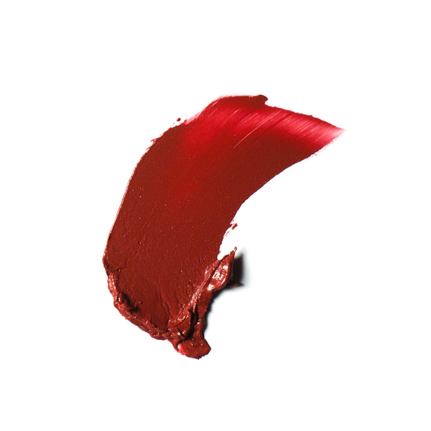 A swatch of the Ere Perez Carrot Colour Pot cream blush in Happy, a rich brick red shade. 