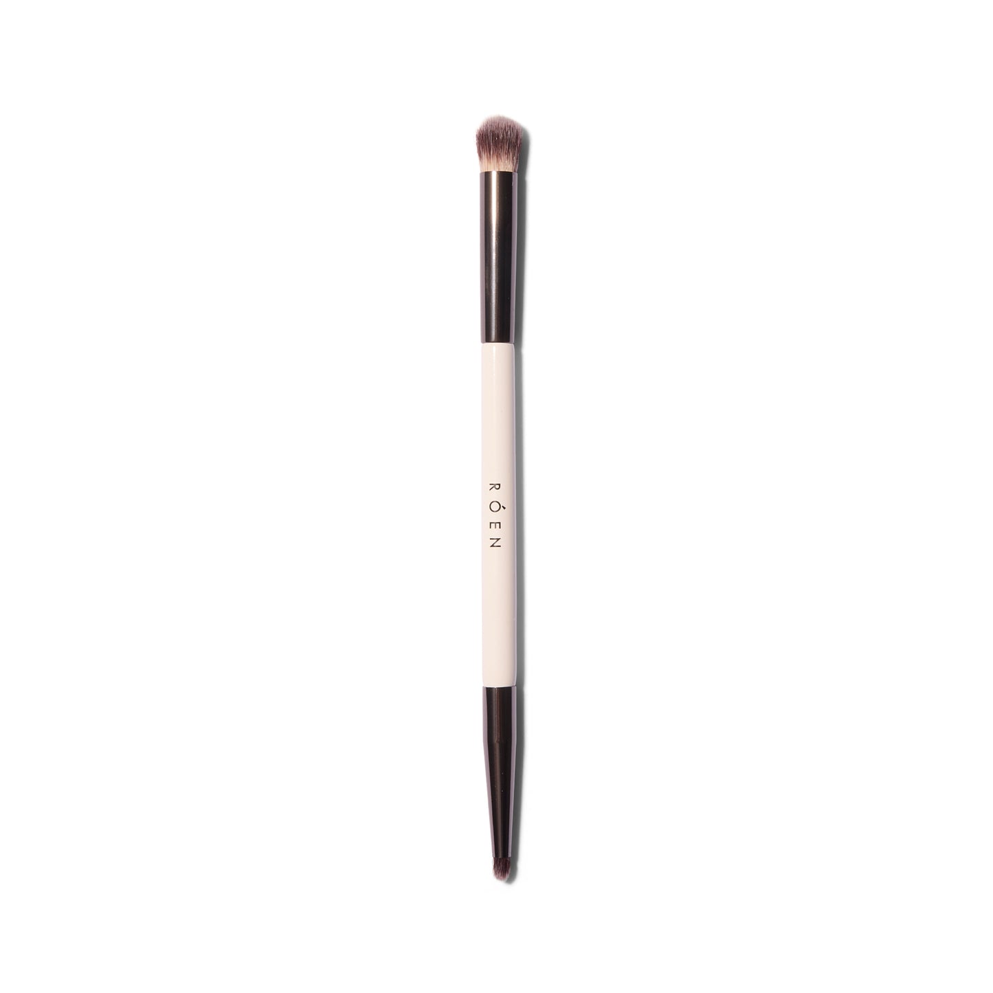 The Roen Everything Eye dual ended eyeshadow brush. One side has a smaller tapered tip and the other is fluffier and dome shaped.