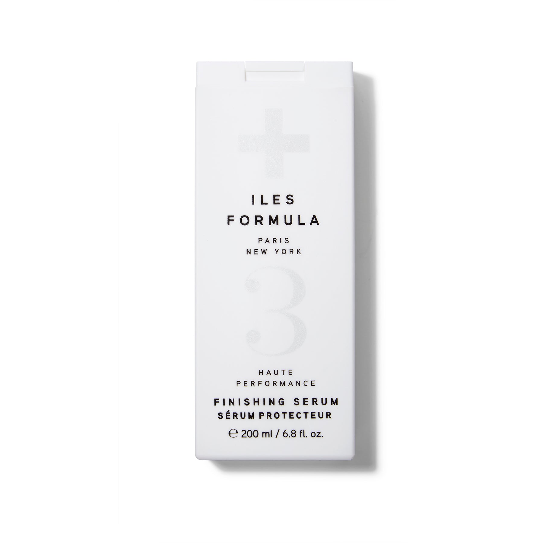 A white rectangular bottle of Iles Formula Finishing Serum with a flip cap. The text is black.