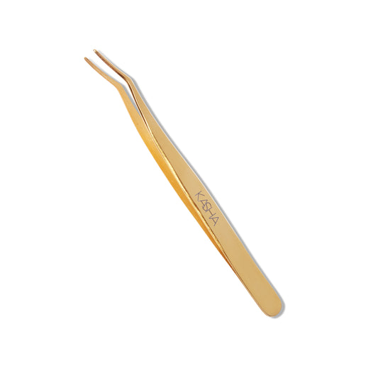 Top view of the gold Kasha Eyelash Applicator. The applicator is gold and the tip is angled.