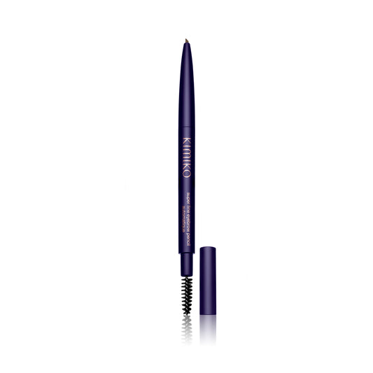 Front view of the Kimono Super Fine Eyebrow Pencil. The pencil is wound up to show the product. The cap is off and to the right of the pencil. You can see the spoolie on the end.
