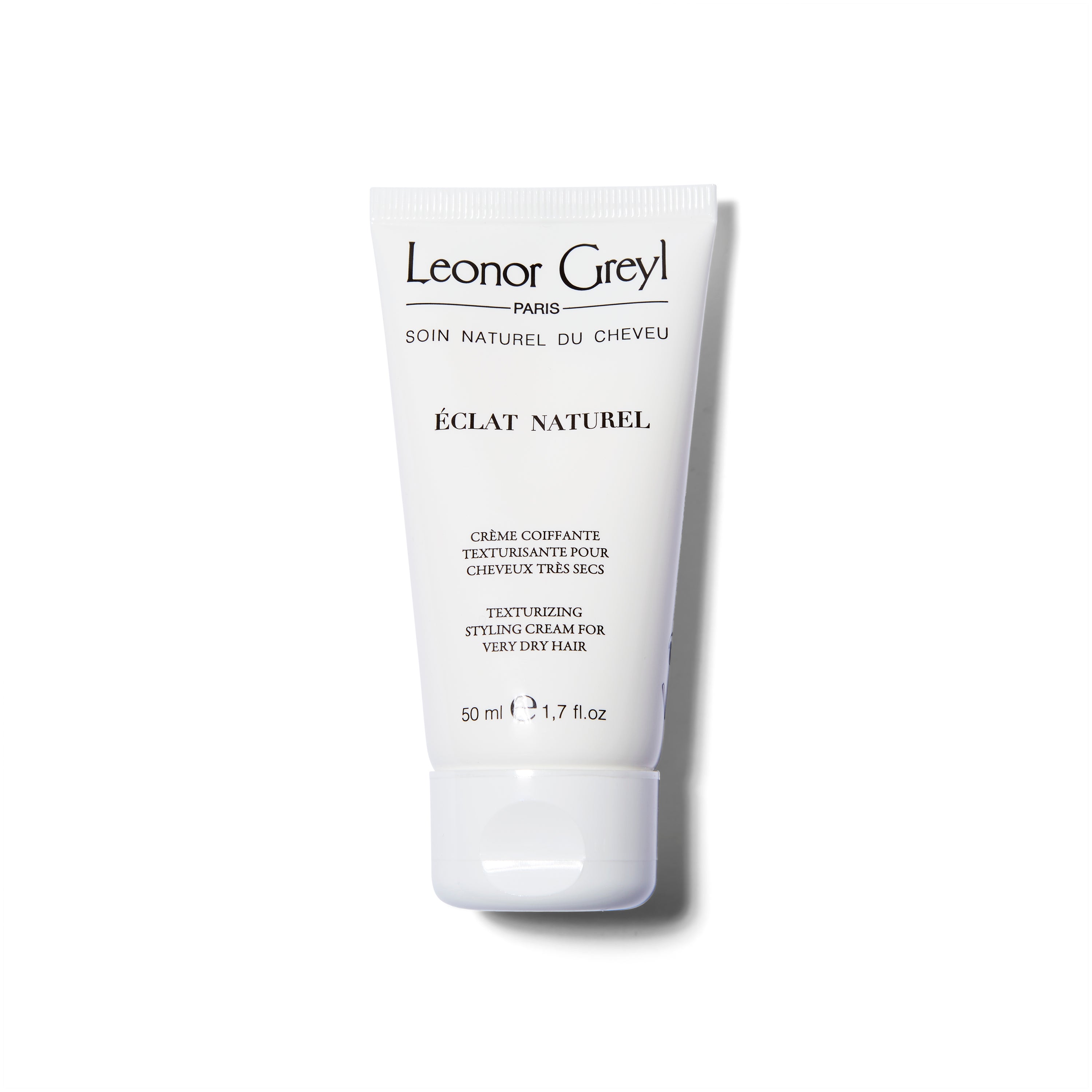 The Leonore Greyl Eclat Naturel white bottle container with black text.