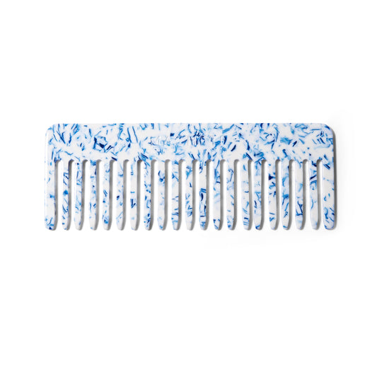 Front view of the blue toile wide toothed comb in sustainable Italian acetate from Machete.