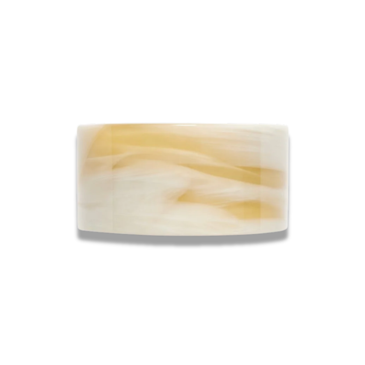 A golden alabaster hair clip on a white background. 