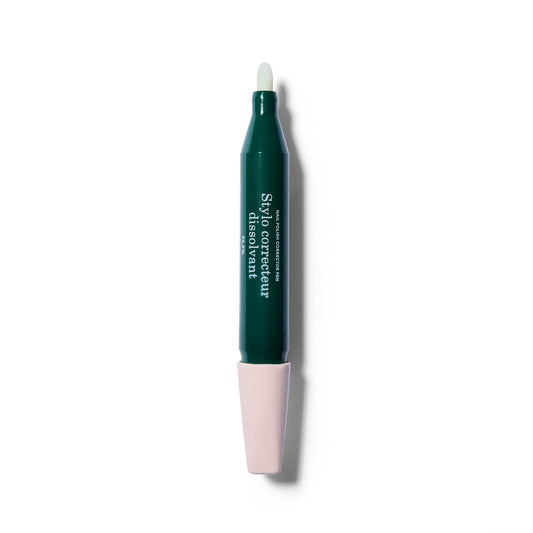 A gren nail polish removing pen. The light pink cap is off, showing the tip of the pen, and attached onto the bottom of the pen.