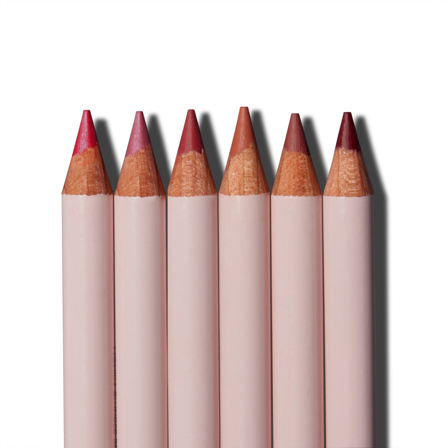 A close up of the tips of the six Monika Blunder Hot Line Lipliner pencils lined up next to each other. 