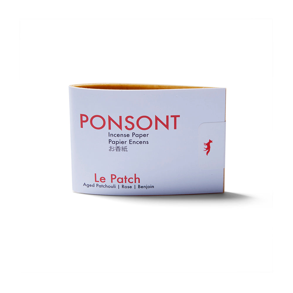 Upright view of the booklet of the Le Patch Ponsont Incense Papers. It's a white small paper booklet with red text.