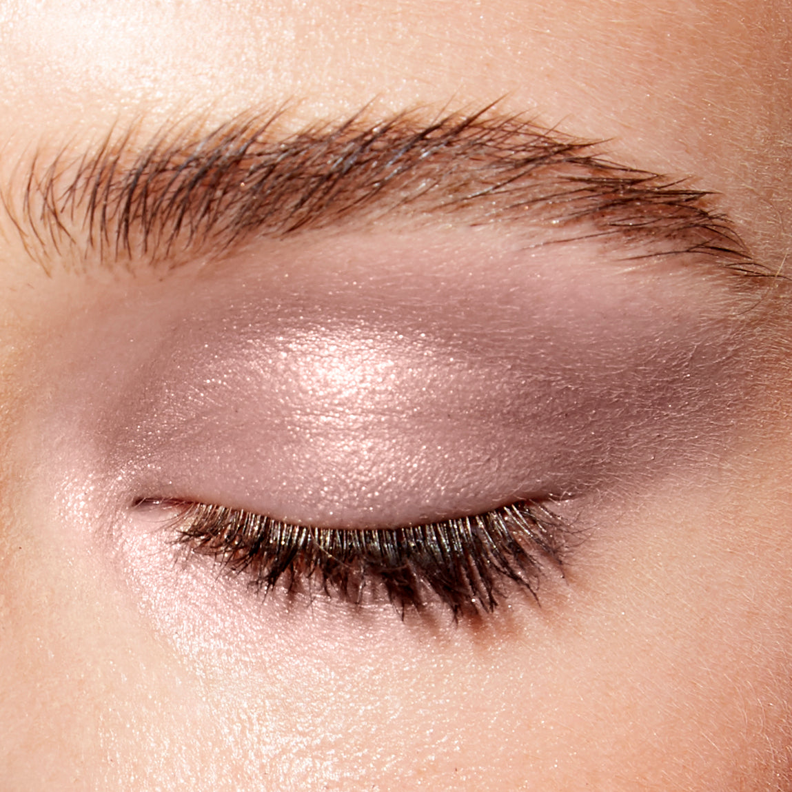 Image of a closed eye and fair skin wearing the Rituel de Fille Ash & Ember Eye Soot in Anima. 