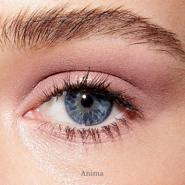 Image of an open blue eye and fair skin wearing the Rituel de Fille Ash & Ember Eye Soot in Anima. 
