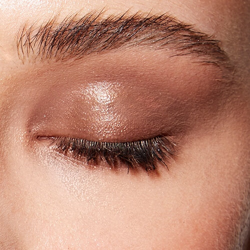 Image of a closed eye and fair skin wearing the Rituel de Fille Ash & Ember Eye Soot in Half Light. 