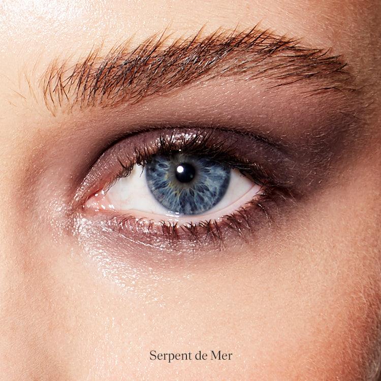Image of a closed eye and fair skin wearing the Rituel de Fille Ash & Ember Eye Soot in Serpent De Mer, a deep purple color.