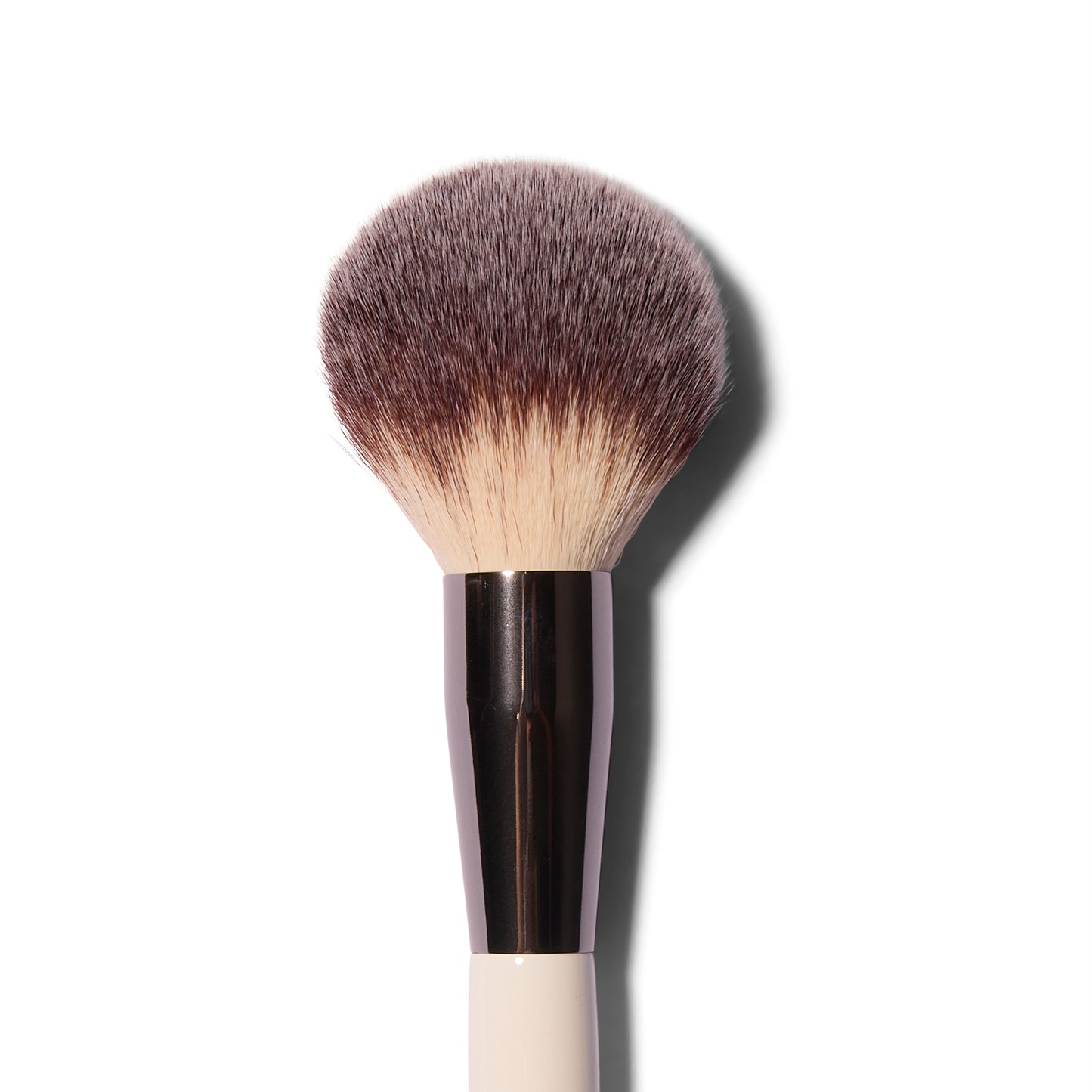 Close up view of the large, fluffy Roen Everything Powder synthetic powder brush with a domed shape.
