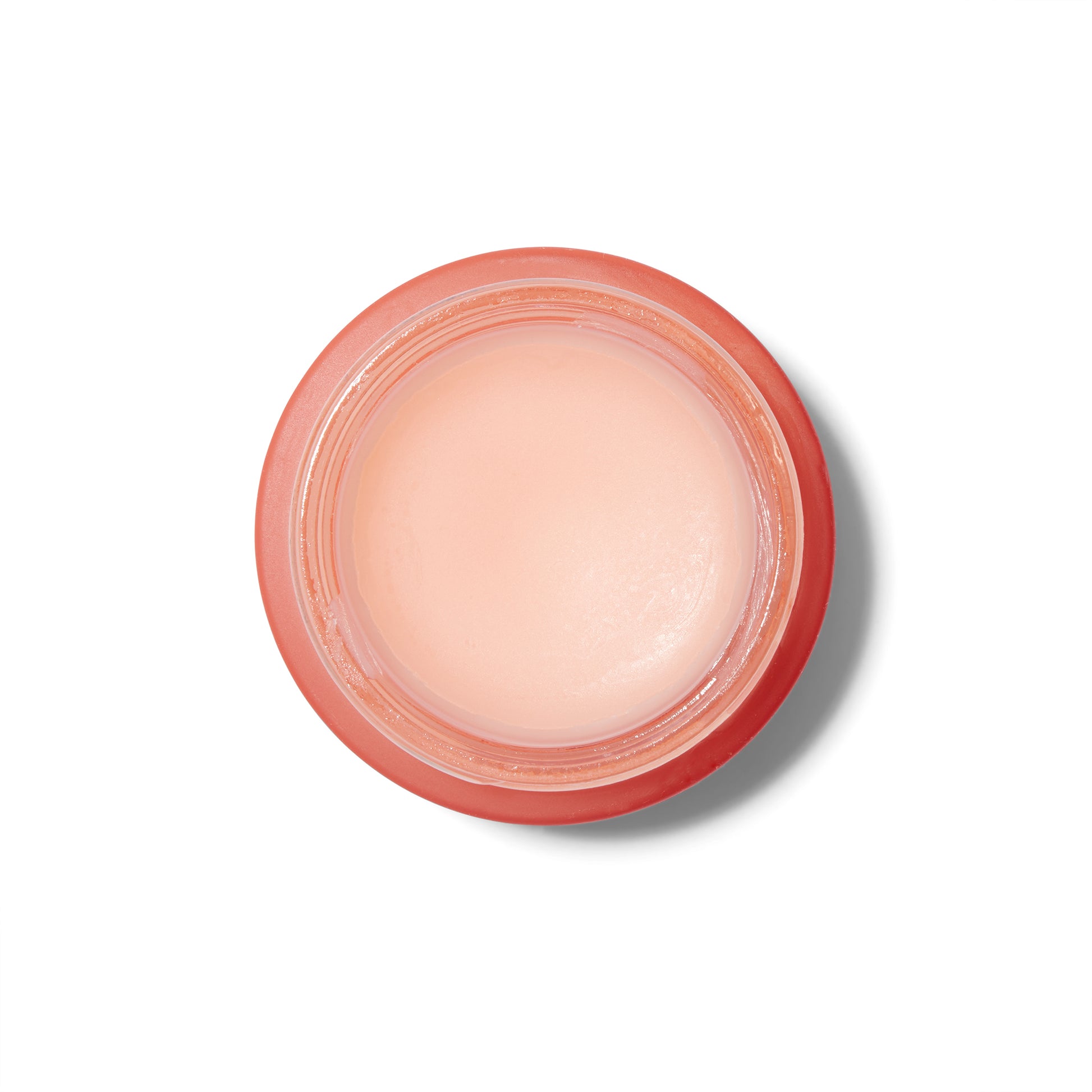 Overhead view of the Rosebud Woman Honor Balm. The jar is a rosy smoked glass and the lid is off showing the pale pink creamy product inside the jar. 