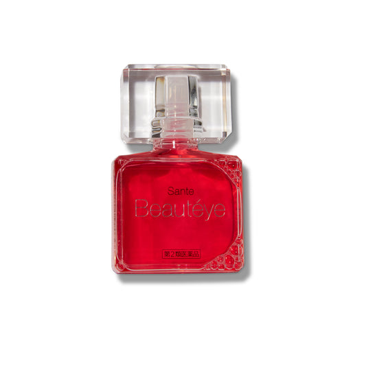 Sante Beauty Eye Drops in their clear container. The top is beveled like a jewel and the liquid in the container is a deep pink color. 