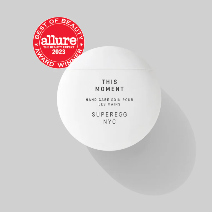 A round white component with black text. The round, red Allure Best In Beauty sticker is to the left of it. 