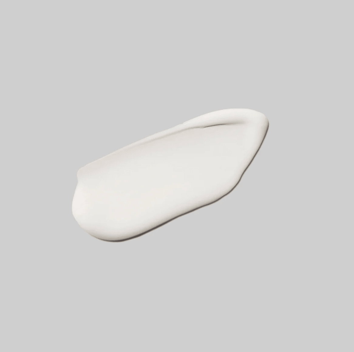 Swatch of a white cream on a grey background. 