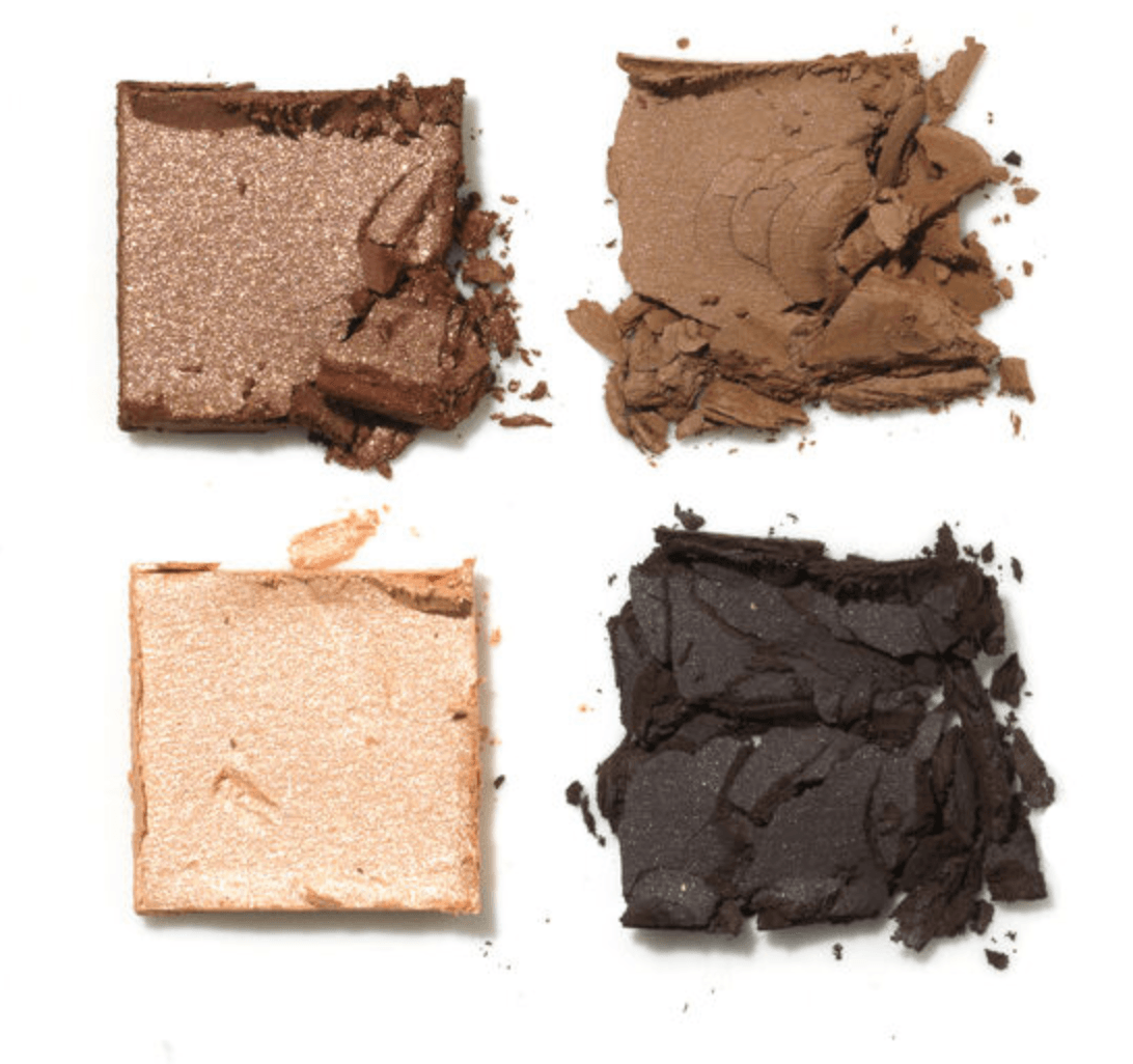 The four shades of the Surratt Beyond Beige Eyeshadow Palette out of the packaging. The shadows are crumbled for artistic effect. 