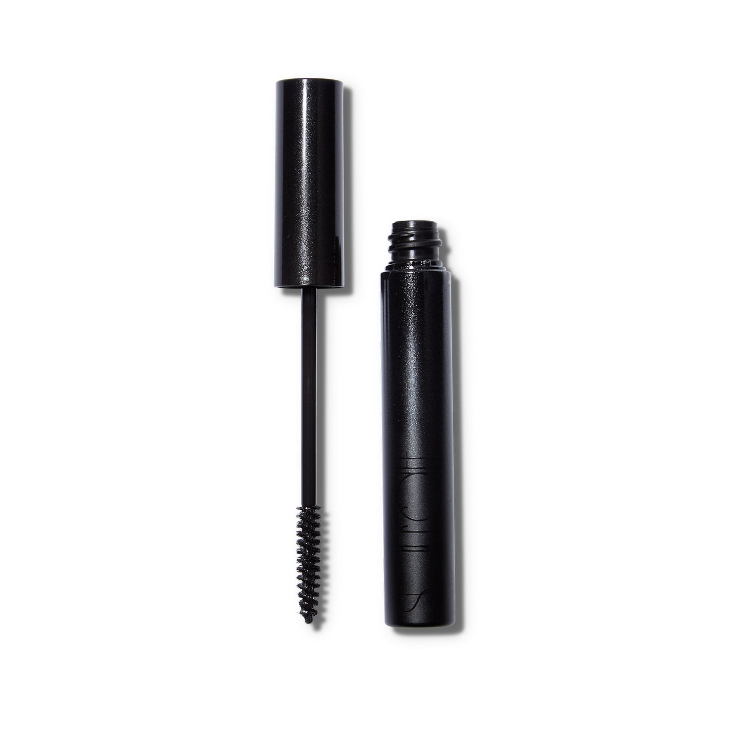 The wand of the Surratt Relevee Mascara is to the left of the open component.